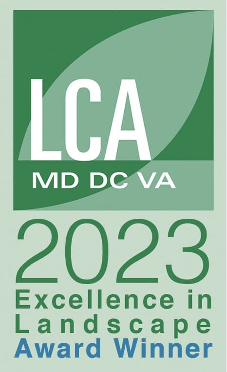 A green logo with "LCA MD DC VA" at the top and "2023 Excellence in Landscape Award Winner" below it. The background features a leaf design.
